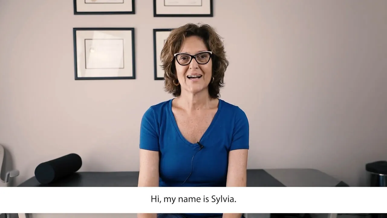 Sylvia, a Live Well Chiropractic patient, seated in the treatment room