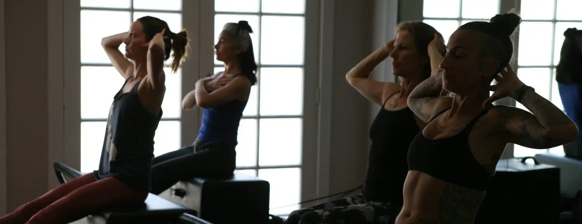 Patients participating in guided Pilates rehabilitation exercises