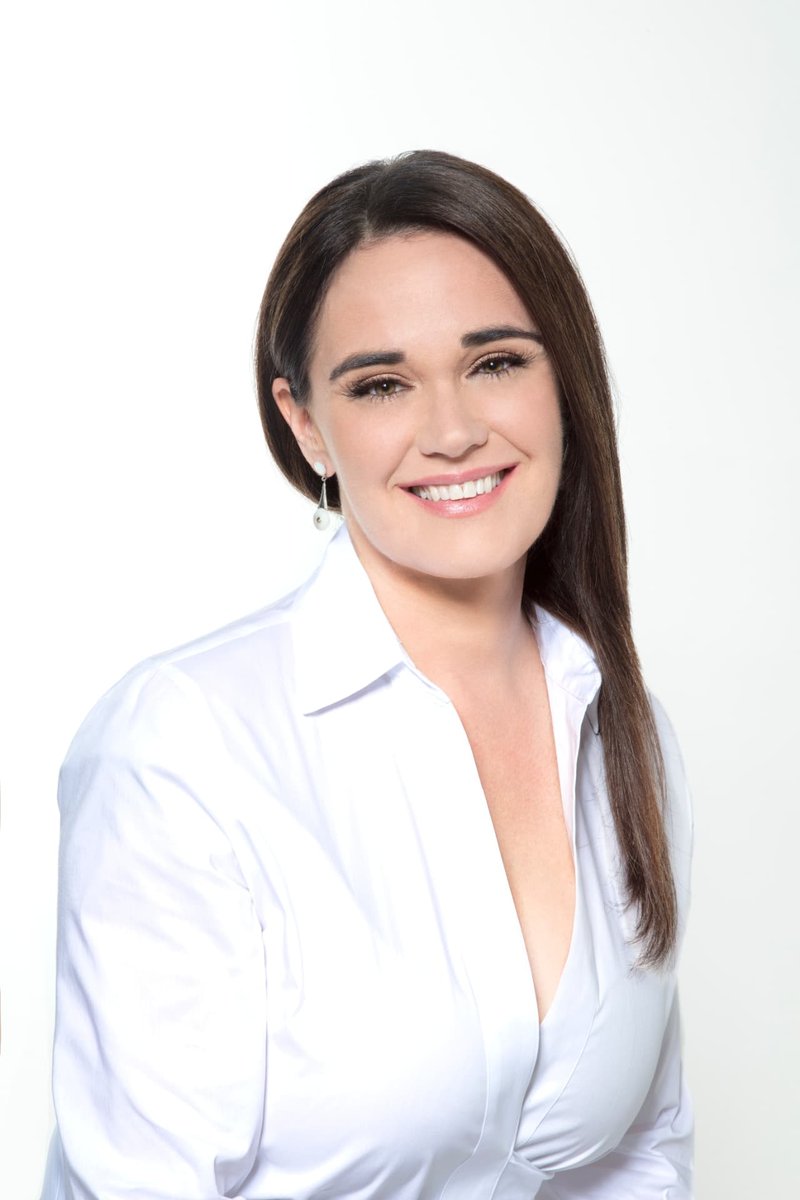 Melissa Monroe, Ph.D., L.Ac., a licensed acupuncturist, smiling in a white blouse